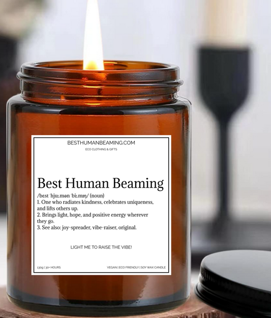 Amber glass soy wax candle with a white label reading “Best Human Beaming” and an uplifting definition about radiating kindness, uniqueness, and positive energy. Eco-friendly, vegan candle gift from Best Human Beaming, perfect for mental wellness and self-care.
