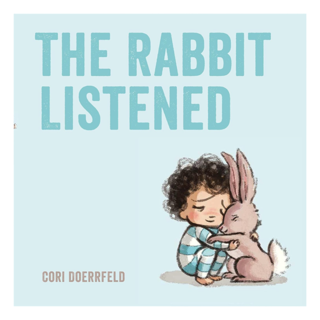 Book cover for “The Rabbit Listened” by Cori Doerrfeld, showing a young child in pajamas hugging a rabbit on a pale blue background. A gentle children’s story about empathy and comfort.