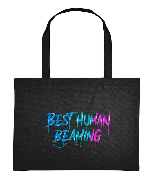 Large black tote bag with long handles, featuring the “Best Human Beaming” logo in a bold blue-to-pink graffiti style. Eco-friendly, vegan tote bag made from recycled cotton and polyester—perfect for shopping, beach days, or everyday use.